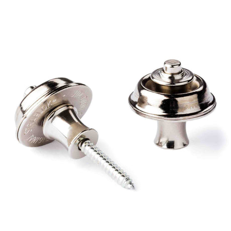 The image shows a pair of chrome or nickel-plated guitar strap locks, consisting of a screw-in part for the guitar body (left) and a locking mechanism (right). These metal accessories securely attach a guitar strap to the instrument, preventing accidental detachment during play. They are durable and commonly used by guitarists for added safety, especially in live performances.