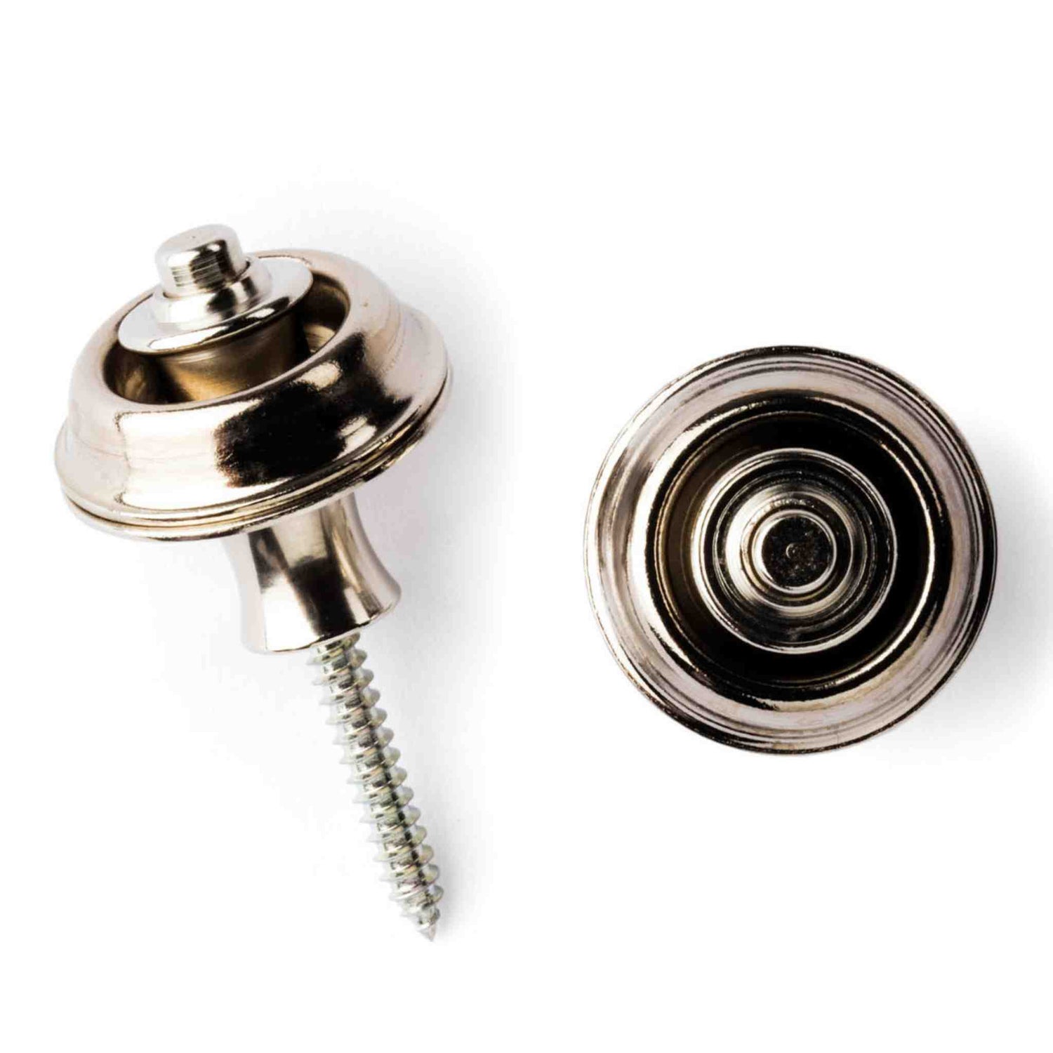 The image shows a pair of guitar strap locks, including a chrome-plated strap button with a screw (left) and a circular strap lock receiver (right). These accessories securely attach a guitar strap to prevent accidental release during play. The locking mechanism offers better security than standard buttons, ideal for active performers. The chrome finish provides a professional look that complements most guitar hardware.