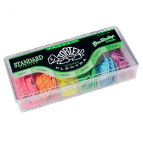 The image shows a Dunlop Tortex Standard guitar pick sampler pack in a clear plastic case. It contains six picks in pink, orange, yellow, green, blue, and purple, each in separate compartments. The case labels pick thicknesses (.50mm to 1.14mm) matching Dunlop’s color-coded system. This sampler lets guitarists test different thicknesses for varied feel and tone, from bright strumming to warm lead playing.