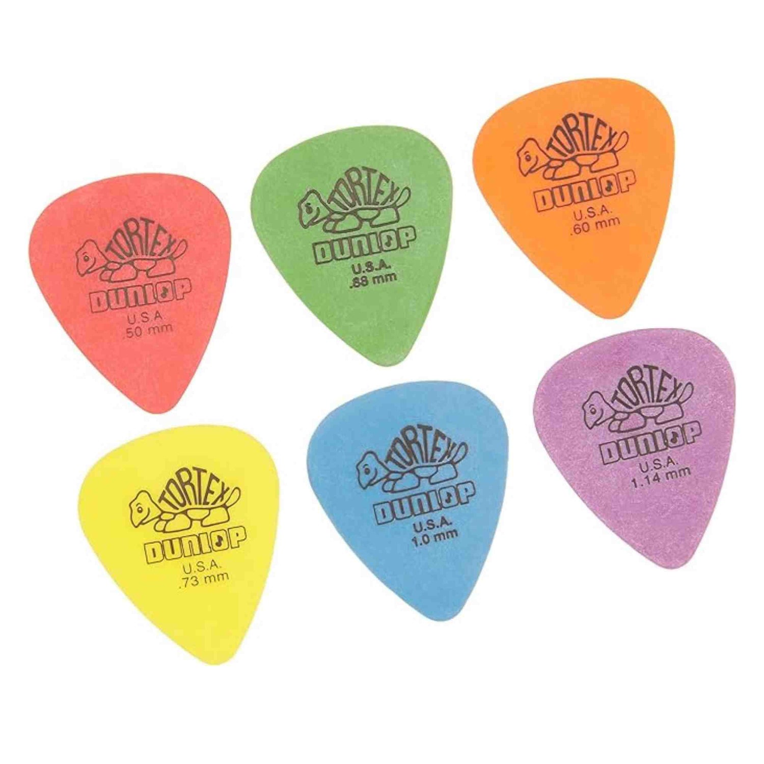 The image shows six colorful Dunlop Tortex guitar picks in red (0.50 mm), yellow (0.73 mm), green (0.88 mm), blue (1.0 mm), orange (1.14 mm), and purple (1.14 mm). Each pick features the Dunlop turtle logo and "U.S.A." marking. These picks vary in thickness for different playing styles, from thin strumming to thick lead playing, representing a standard Tortex variety pack popular among guitarists.
