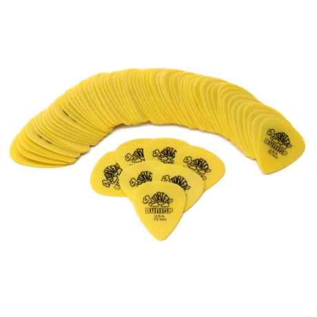 The image shows a collection of yellow Dunlop guitar picks arranged in two groups: a large semi-circle and a smaller cluster of 7-8 picks. Each pick features the Dunlop logo in black and appears to be medium gauge. These essential guitar accessories are commonly used for strumming or plucking strings, and Dunlop is known for producing high-quality picks favored by many guitarists.