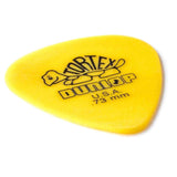 The image shows a yellow Dunlop Tortex guitar pick with the "TORTEX" text at the top, "DUNLOP" branding and turtle logo in the center, "U.S.A." manufacturing mark, and ".73 mm" thickness. This medium gauge pick is made of durable Delrin, offering good grip and balanced tone. It has a standard teardrop shape for versatile guitar playing.