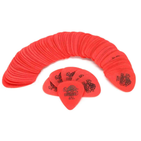 The image shows a collection of red Dunlop guitar picks arranged in a curved, fan-like pattern on a white background. The picks are standard teardrop shape, likely medium gauge. Dunlop branding is visible on several picks. These bulk picks are common for guitarists, as picks are frequently lost or worn out during play.