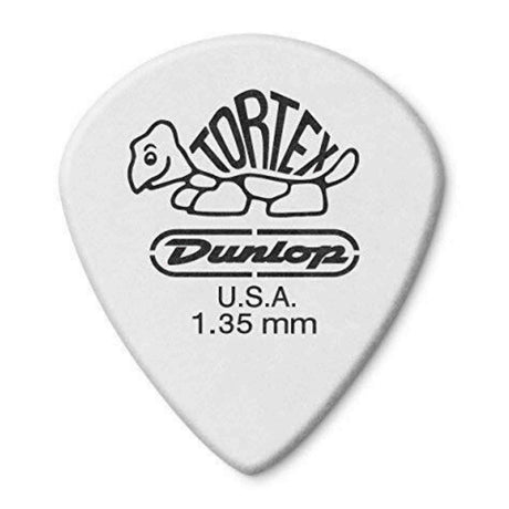 The image shows a Dunlop Tortex guitar pick with a classic teardrop shape in white/light gray. It features the iconic turtle logo with "TORTEX" text, "Dunlop" branding below, a "U.S.A." mark, and a thickness label of 1.35 mm. This heavy gauge pick is known for its durability, textured grip, and synthetic material that mimics traditional tortoise shell tones.