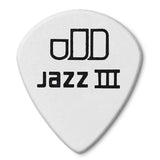 The image shows a white Jazz III guitar pick (plectrum) with black text reading "oDD" and "Jazz III." Known for its small, pointed shape, the Jazz III is popular among guitarists in jazz, rock, and metal for its precision and control during fast, intricate playing. The "oDD" likely indicates a brand or series. Guitar picks come in various sizes and materials to fit different styles and preferences.