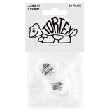 The image shows a 12-pack of Dunlop Tortex Jazz III guitar picks, each 1.35mm thick. The packaging displays the Tortex turtle logo, visible on the white/clear picks inside. Known for durability and grip, these small, pointed Jazz III picks offer precise control and a bright attack, favored by lead guitarists and players seeking a firm, fast-playing pick.