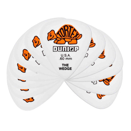 The image shows a fan of white/clear Dunlop Tortex "The Wedge" guitar picks, each 0.60mm thick. They display Dunlop's orange tortoise logo and feature a triangular shape for better grip and playability. This medium-thickness pack, likely containing 6 or 12 picks, highlights their popularity for durability and versatile use among guitarists.
