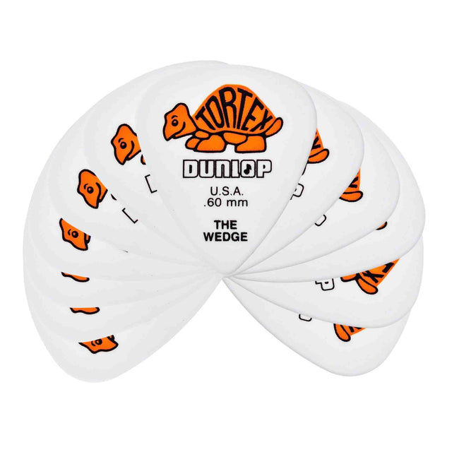 The image shows a fan of white/clear Dunlop Tortex "The Wedge" guitar picks, each 0.60mm thick. They display Dunlop's orange tortoise logo and feature a triangular shape for better grip and playability. This medium-thickness pack, likely containing 6 or 12 picks, highlights their popularity for durability and versatile use among guitarists.