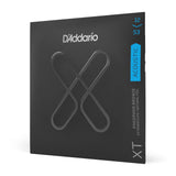 The image shows a package of D'Addario XT acoustic guitar strings. It features the XT series, known for extended life and natural feel, with a 12-53 medium gauge phosphor bronze set. The black packaging displays the distinctive "X" design, highlighting the coated strings that offer durability without sacrificing tone quality.