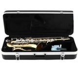 The image shows a lacquered brass tenor saxophone with mother-of-pearl key touches, resting in a black hard case with silver trim and metal latches. The case interior is padded with black lining and includes a light blue or white cleaning cloth. The saxophone features the characteristic curved body, multiple keys, and mechanical linkages, suggesting a professional or semi-professional instrument suitable for intermediate to advanced players.