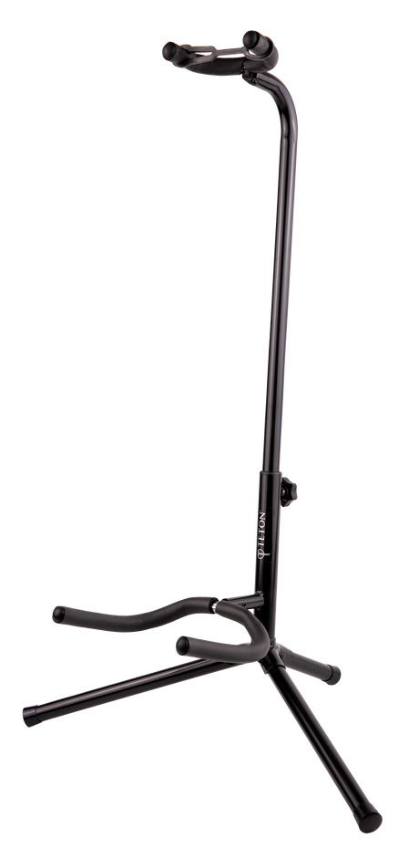 The image shows a black TETON guitar stand with a tripod base and adjustable vertical pole. It has padded curved yokes to cradle the guitar’s body and a lower support arm for the guitar’s bottom. Designed for acoustic or electric guitars, the stand offers stable, secure storage and protection from scratches, making it ideal for home, studio, or stage use.