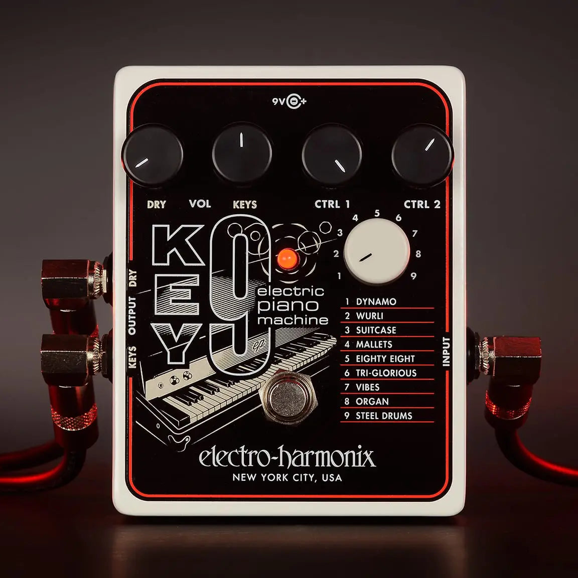 Front view of the Electro-Harmonix Key9 Piano synth pedal with cables connected on the sides and controls visisble.