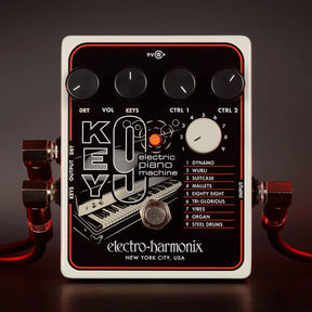 Front view of the Electro-Harmonix Key9 Piano synth pedal with cables connected on the sides and controls visisble.