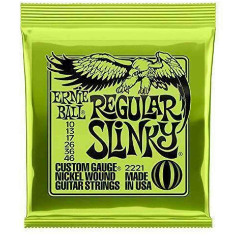 The image shows a package of Ernie Ball Regular Slinky electric guitar strings, model 2221, with bright green packaging and the eagle logo. It contains nickel-wound strings in the 10-46 gauge set (10, 13, 17, 26, 36, 46). This popular set offers a balanced tone and playability, favored by guitarists across genres. Ernie Ball is a trusted brand known for quality guitar strings.