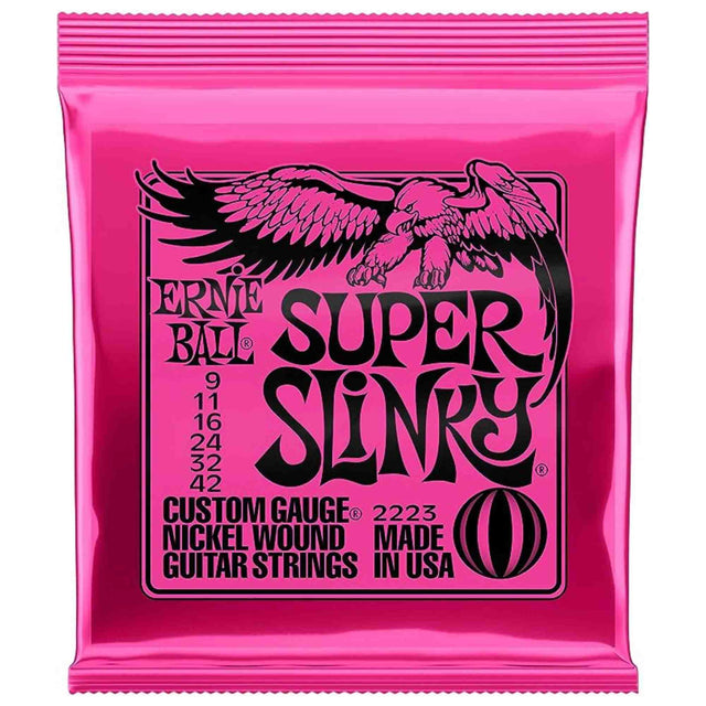 The image shows a bright pink Ernie Ball Super Slinky electric guitar strings package. It is a resealable zip-top bag featuring the black eagle logo. The strings are light gauge (9-42), nickel wound custom gauge, model 2223, made in the USA. Known for easy playability and balanced tone, these strings are popular among rock, pop, and blues guitarists.