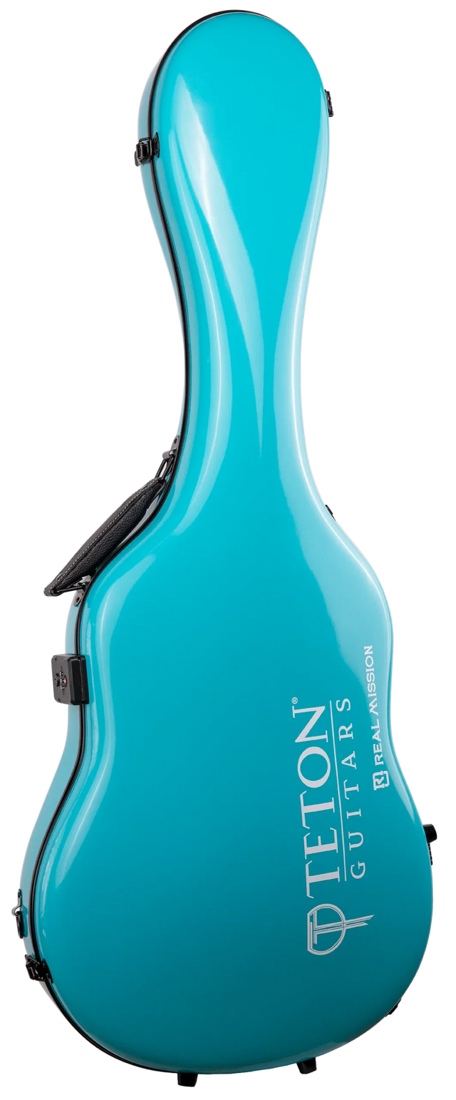 The image shows a modern hard shell guitar case from Teton Guitars in a glossy turquoise/teal finish. It features the distinctive guitar shape with "TETON GUITARS" and "BOZEMAN" in white lettering on the front. Made of molded fiberglass or similar material, it has black latches and a carrying handle. The bright color makes it stand out, offering strong protection and a sleek, professional look.