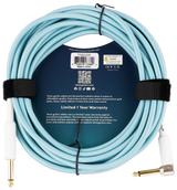 The image shows a light blue Teton guitar cable (model TTGC20R) with fabric braiding and gold-plated 1/4" connectors made by Chesebro Music Company, Idaho Falls. It features a durable 6.5mm jacket, premium gold jacks for clear, noise-free sound, professional-grade build, a 1-year limited warranty, Teton branding, a QR code, and links to tetonguitars.com and social media.