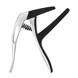 The image shows a sleek guitar capo with a polished silver/chrome metal frame and black rubber padding on contact points. The spring-loaded mechanism, visible on the capo, clamps it securely on the fretboard to raise the pitch of all strings simultaneously. The black rubber protects the guitar’s neck and strings, while engraved text is visible on the metal body. This essential accessory allows easy key changes using the same chord fingerings.