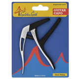 The image shows a Golden Gate guitar capo for steel-string guitars in retail blister packaging. The capo features a silver metal body with black rubber padding and a spring-loaded clamp with an ergonomic handle. The packaging has a blue background with red accents, displays the Golden Gate Bridge logo, sagamusic.com, and states it is made in China. The capo clamps the fretboard to raise pitch and change keys easily.