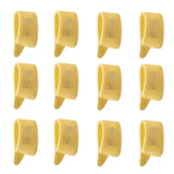 The image shows 12 yellow/amber guitar picks arranged in a 3x4 grid. They are standard picks made from translucent or semi-transparent plastic, possibly celluloid. Each pick features text or branding, though it is not clearly legible. These classic-colored picks are typical accessories used by guitarists to strum or pluck strings, suggesting a vintage or traditional style.