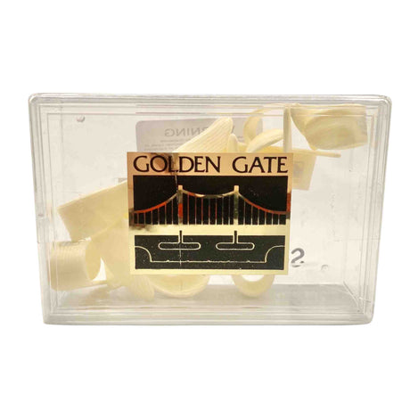 The image shows a clear plastic case labeled "GOLDEN GATE" with a logo of the Golden Gate Bridge, containing several light-colored cane reeds. These flat, thin, slightly curved single reeds are used for woodwind instruments like saxophones or clarinets. The transparent case protects the reeds from damage and moisture while allowing musicians to view them.