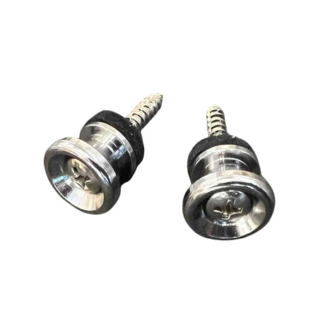 The image shows two guitar strap locks, essential accessories that securely attach a strap to a guitar and prevent slipping. Each lock has a threaded screw installed in the guitar body and a clear locking mechanism with internal springs. The chrome or nickel-plated locks click onto the screw button and release by pressing the mechanism, offering more security than standard strap buttons, ideal for valuable instruments and energetic play.