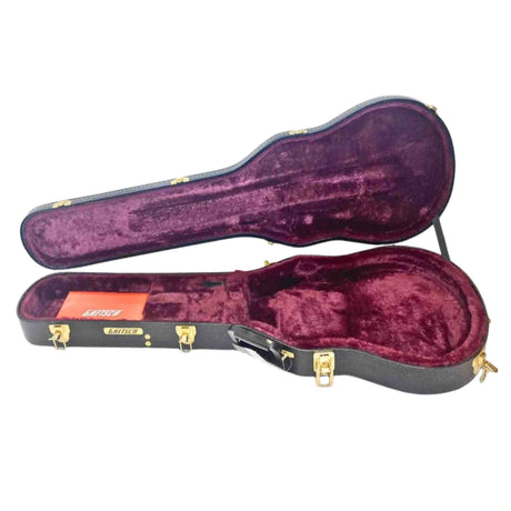 Open guitar case with maroon interior on a white background