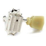 The image shows a Grover guitar tuning peg with a chrome, vintage-style metal housing, a visible gear mechanism, a cream plastic tuning knob, and a metal post for string winding. This high-quality tuner combines decorative design and precise function, typically used in sets of six on guitar headstocks to adjust string tension and tune the instrument.