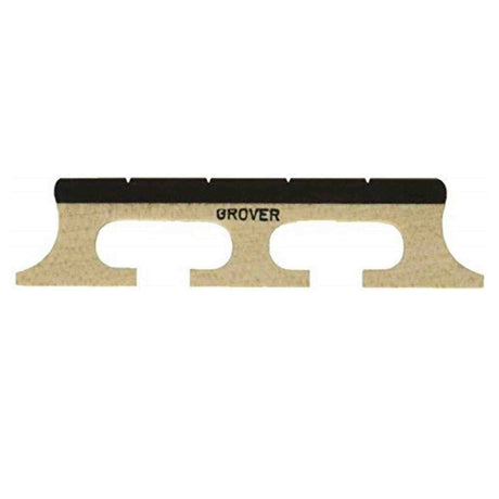 The image shows a Grover violin bridge made of light-colored wood, likely maple. It features the typical arched shape with two curved cutouts for strings, with "GROVER" printed on the top edge. The bridge has a thin, precise profile and two feet at the bottom that rest on the violin’s top plate. This essential component transfers string vibrations to the instrument’s body and requires careful fitting by a luthier.