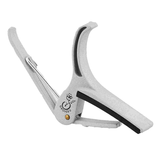 The image shows a silver-gray, spring-loaded clamp-style guitar capo by Grover. It features a curved metal frame with black rubber padding to protect the guitar neck and strings. Designed for easy one-handed use, the lightweight capo clamps across the fretboard to raise the pitch of all strings, enabling guitarists to play in different keys while using the same chord shapes.