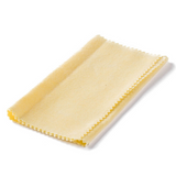 The image shows a golden-yellow polishing cloth with serrated edges, commonly used for cleaning and maintaining musical instruments. Made of microfiber or chamois material, it helps remove fingerprints, dust, and moisture from guitars, brass, woodwind, string instruments, and piano surfaces, protecting finishes and ensuring instrument longevity.