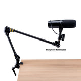A podcasting mic attached to an adjustable mic stand clamped to a table