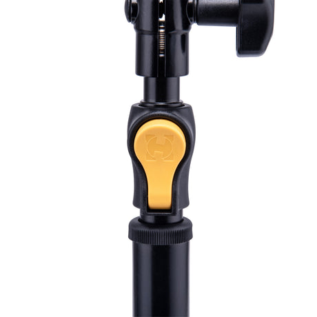 A black stand with a yellow adjustment button on a white background