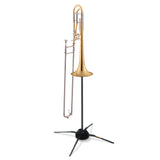 Trombone resting on a black trombone stand on a white background