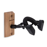 A black violin hanger with a wood base on a white background