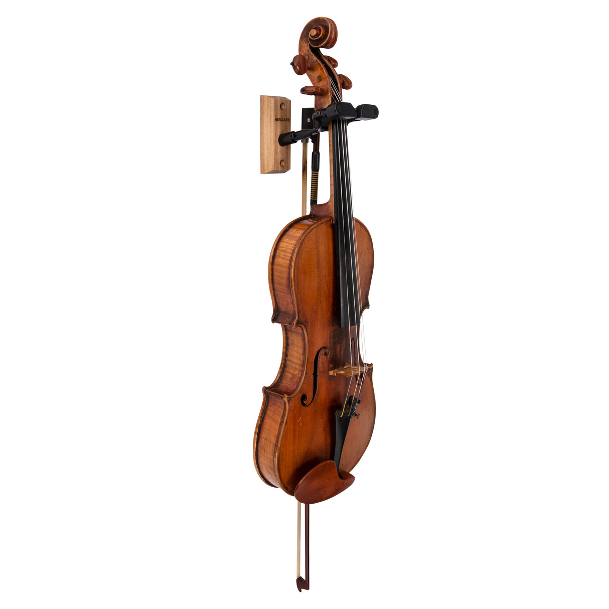 A violin hanging on a black violin hanger on a white background