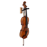 A violin hanging on a black violin hanger on a white background