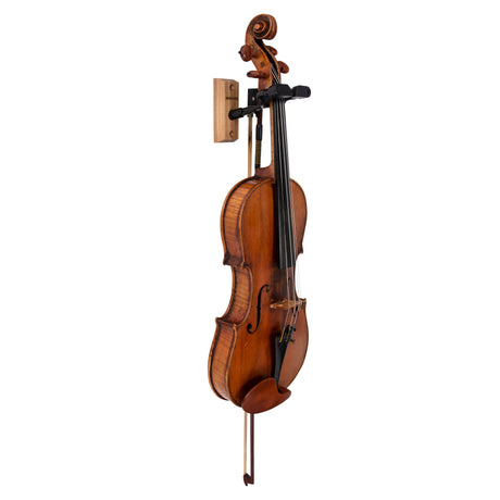 A violin hanging on a black violin hanger on a white background