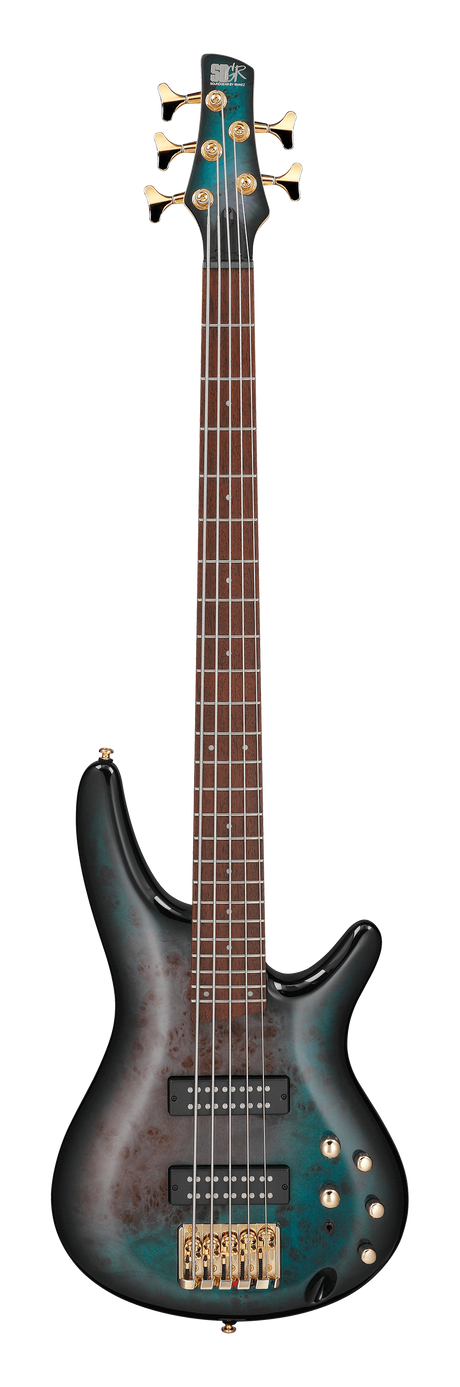The image shows a beautiful 5-string electric bass guitar with a teal/turquoise burst finish and a classic double-cutaway body. It features two black humbucker pickups, gold hardware, multiple control knobs, and a rich brown fretboard with light markers. The gold tuning pegs match the five strings. A logo is faintly visible on the headstock. This high-end instrument combines premium craftsmanship with professional design for serious musicians.