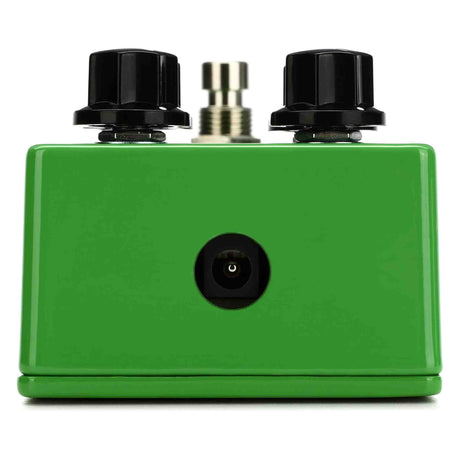 Green guitar effects pedal with black knobs on a white background