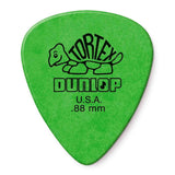 The image shows a bright green Dunlop Tortex guitar pick featuring the classic turtle logo with "TORTEX" on the shell, "DUNLOP," "U.S.A.," and ".88 mm" thickness. This medium-heavy pick is popular for its durability, grip, and matte finish. The green color indicates its thickness in Dunlop’s color-coded system, offering versatility for both rhythm and lead guitar playing.