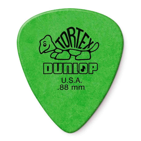 The image shows a bright green Dunlop Tortex guitar pick featuring the classic turtle logo with "TORTEX" on the shell, "DUNLOP," "U.S.A.," and ".88 mm" thickness. This medium-heavy pick is popular for its durability, grip, and matte finish. The green color indicates its thickness in Dunlop’s color-coded system, offering versatility for both rhythm and lead guitar playing.