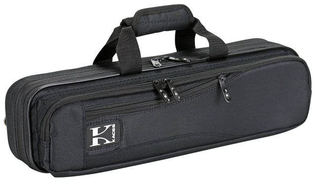 The image shows a black soft-sided flute case with a durable nylon or canvas exterior. It has dual padded carry handles, multiple zippered compartments for storage, and a brand logo patch (possibly "Kaces"). Designed for professional protection, the case is ideal for flute players to safely transport their instrument and accessories like cleaning cloths and sheet music.