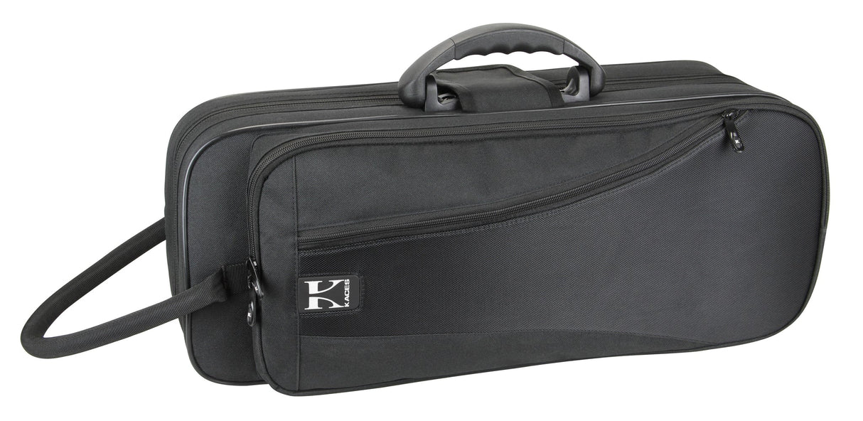 The image shows a black, soft-sided musical instrument case, likely for a trumpet or similar brass instrument. It has a sturdy handle, adjustable shoulder strap, multiple zippered compartments, and a "K" brand label, possibly Kaces. The case is designed to protect instruments and store accessories like mouthpieces and valve oil, featuring professional black styling typical of performance-grade cases.