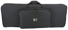 The image shows a black soft-sided keyboard gig bag with padded protection, multiple carrying handles, and several zippered compartments for an electronic keyboard or digital piano. It features a white "K" logo, likely from the Kaces brand, and includes storage pockets for accessories, making it lightweight and portable for musicians transporting their instruments and gear.