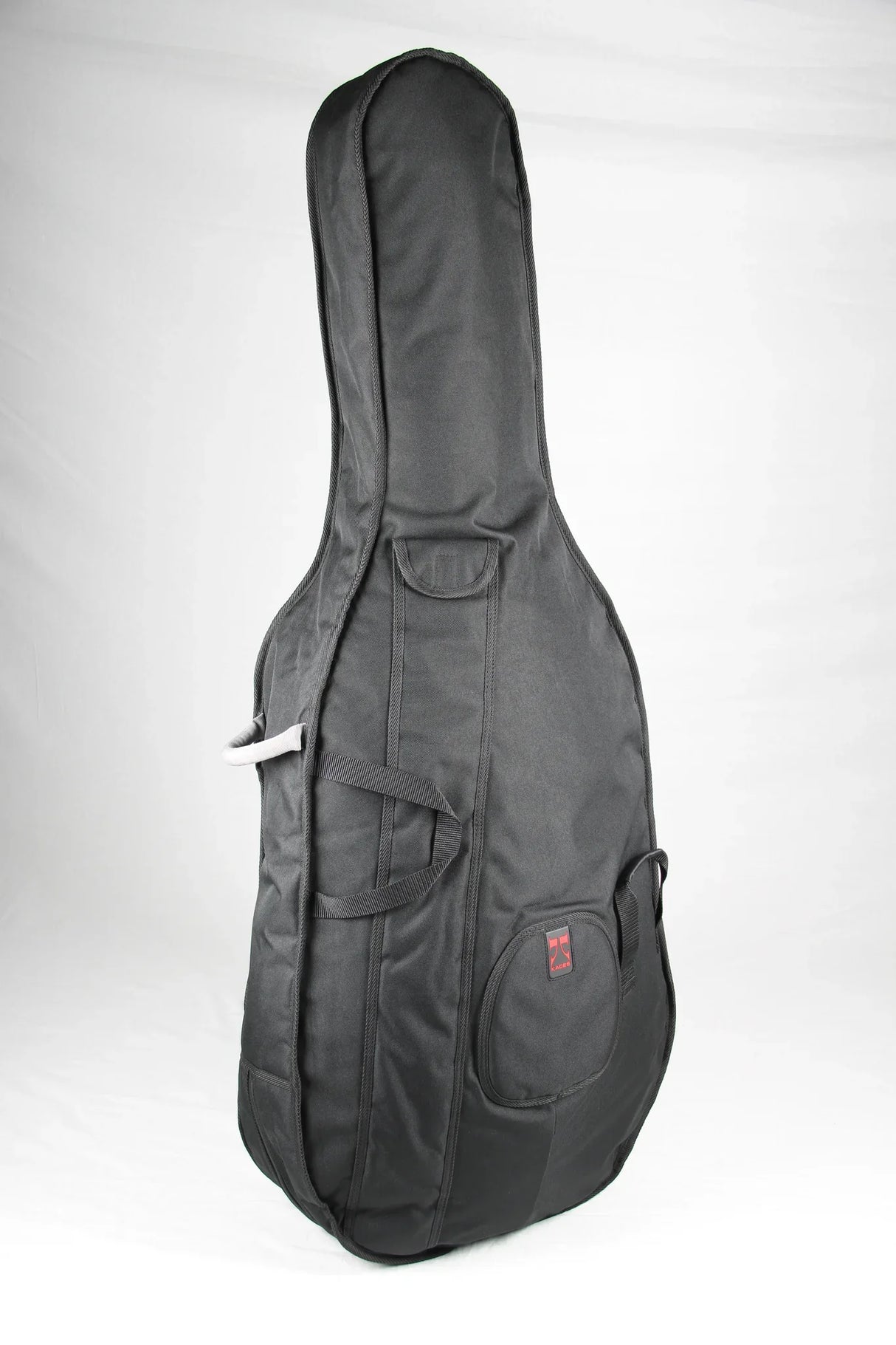 The image shows a dark gray padded guitar gig bag with a guitar-shaped silhouette, suitable for acoustic or electric guitars. It features multiple carrying handles, a zippered external pocket with a small red/orange logo, heavy-duty zippers, and reinforced stitching. Designed for lightweight, portable protection, it’s ideal for transporting guitars to gigs, lessons, or rehearsals.