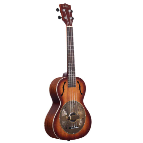 The image shows a resonator ukulele, combining traditional ukulele design with a metal resonator cone for louder, metallic sound. It features a sunburst finish, f-holes on either side of the cone, and a tenor or concert-sized body with four strings. The headstock displays the Kala brand with standard tuning pegs and a dark wood neck with fret markers. This instrument offers portability with enhanced volume and a distinctive tone.