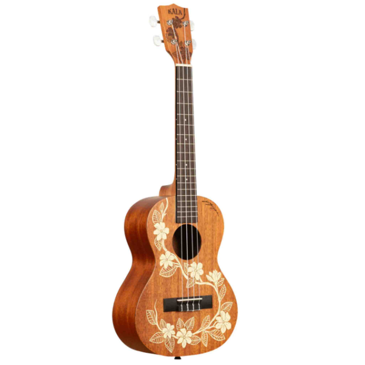 The image shows a Kala tenor or concert ukulele made of warm-toned wood, likely mahogany, with a traditional figure-8 body shape. It features a dark fretboard, chrome tuning pegs, and the "KALA" logo on the headstock. The body showcases an elegant white hibiscus floral inlay in a Hawaiian style. This decorated model combines artistic design with quality craftsmanship typical of Kala instruments.