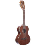 The image shows a tenor or concert-sized ukulele with a rich dark wood body, light binding, and a traditional figure-8 shape. It has four strings, eight tuning pegs on the headstock, a central sound hole, a wooden bridge, and frets along the neck. The instrument’s quality is evident in its wood grain and finish. Ukuleles are small, guitar-family instruments known for their bright, cheerful sound, popular in Hawaiian and folk music.