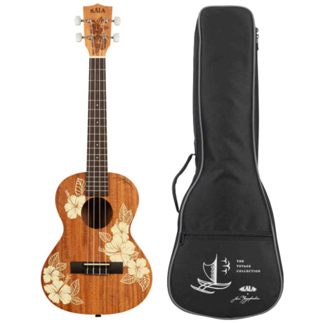 The image shows a KALA ukulele with a natural wood finish and white hibiscus flower and leaf designs on the body. It has four strings, white tuning pegs, and a dark fretboard with position markers, likely a concert or tenor size. Next to it is a black soft gig bag from "The Voyage Collection" featuring a sailing ship logo, KALA branding, a handle, and shoulder strap attachments, designed to fit this ukulele.
